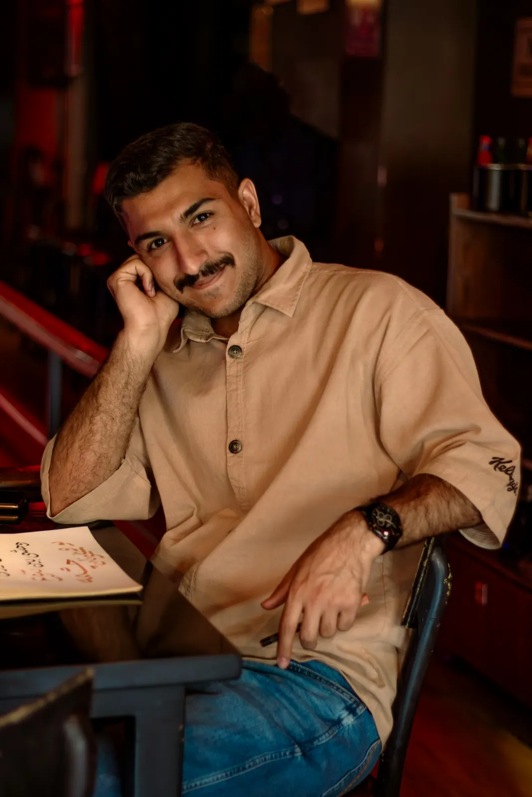 Model wearing a relaxed-fit sand shirt