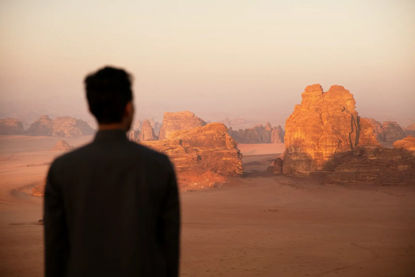 Model in a dark suit in the desert