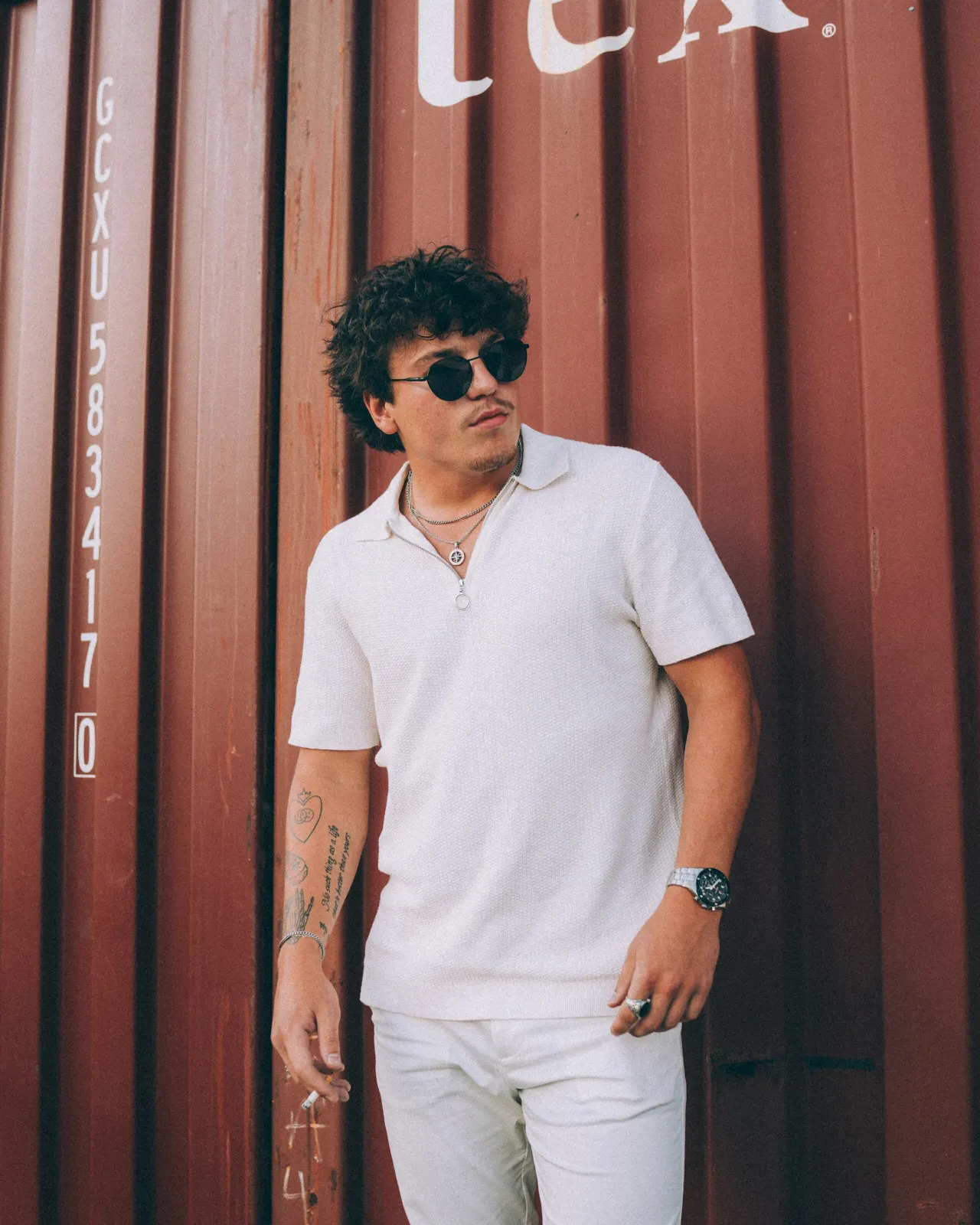 Model in a cream knit polo